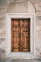 Fototapeta na wymiar Ancient wooden door of an Ottoman style mosque, in Istanbul, Turkey.