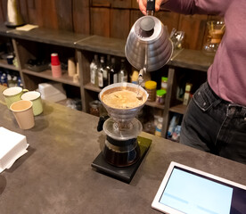 Woman barista making drip coffee
