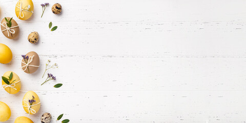 Easter eggs with flowers on a white table.
