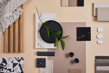 Creative flat lay composition of interior designer and architect moodboard. Textile and paint samples, lamella panels and lastrico tiles. Beige, black and green color palette. Copy space. Template.