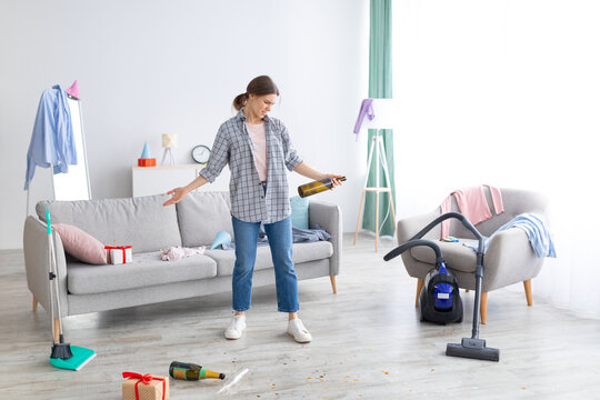 Disgusted millennial lady standing in messy flat after party, not willing to do cleanup, empty space