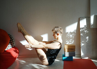 Navasana yoga woman sunday home