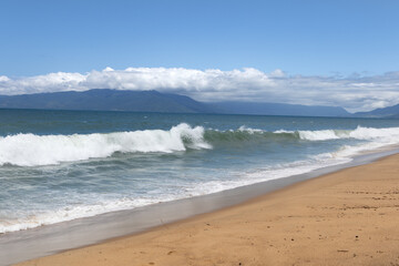 wave breaking on the beach in sunny day