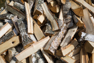 pile of birch split firewood. background