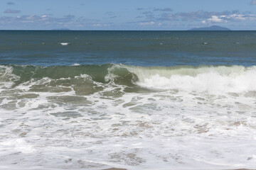 wave breaking on the beach in sunny day