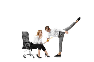 Co-workers. Two stylish office workers in business suits in action isolated on white background....