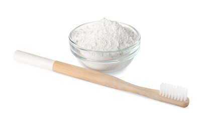 Glass bowl of tooth powder and brush on white background