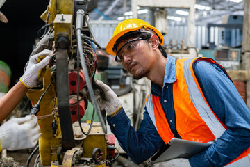 asian engineering worker man wearing uniform safety and hardhat working machine lathe metal in...