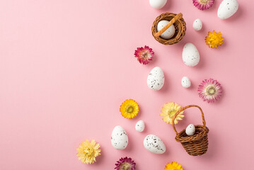 Top view photo of easter decorations wild flowers and easter baskets with eggs on isolated pastel...