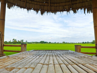 Surface of bamboo table is beautifully laid out which the beautiful rice field