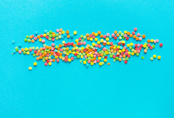 Background of colorful candies. Rainbow topping for topping ice cream and cakes. Happy Easter!