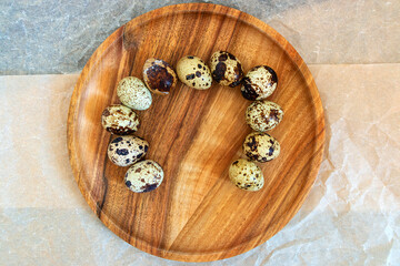Quail eggs on a wooden plate