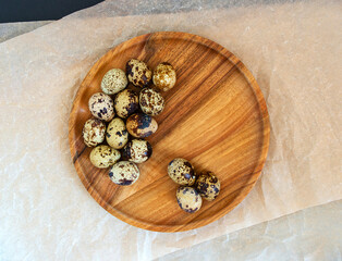 Quail eggs on a wooden plate