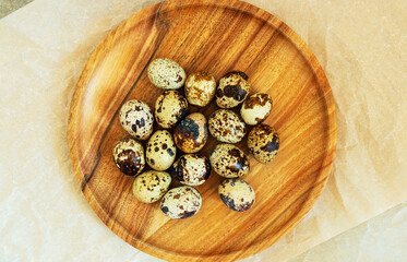 Quail eggs on a wooden plate