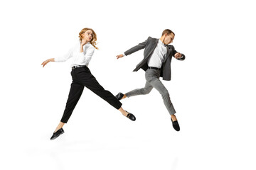 Fototapeta na wymiar Busy day. Two stylish office workers in business suits in action isolated on white background. Art, beauty, fashion and business concept