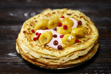 Pancakes with caramelized banana, yogurt and berries. Healthy dessert. Maslenitsa.