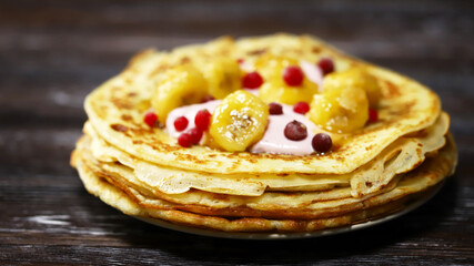 Pancakes with caramelized banana, yogurt and berries. Healthy dessert. Maslenitsa.