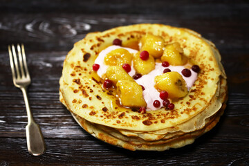 Pancakes with caramelized banana, yogurt and berries. Healthy dessert. Maslenitsa.