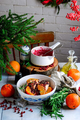 Baked salmon with tangerines in cranberry sauce in a white pan.style vintage