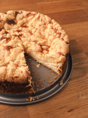 Homemade traditional cheesecake with sprinkles on a wooden kitchen table