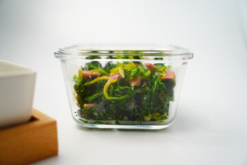 Sigeumchi namul is a Korean side dish. It is Parboiled spinach seasoned with salt, chopped green onion and garlic, sesame oil, and sesame seeds