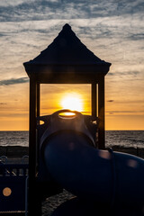 Sunrise through a slide at the playground