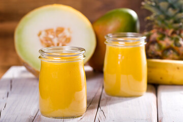 pineapple and mango melon shake on white wood