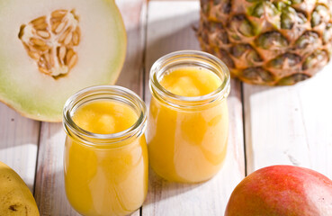 pineapple and mango melon shake on white wood