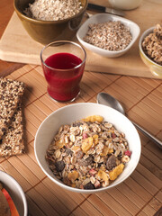 Rich breakfast with organic cereals and ingredients on a wooden table, healthy food concept