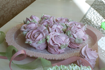 Roses, tulips and chrysanthemums from marshmallows. Zephyr flowers. Sprinkled with powdered sugar.