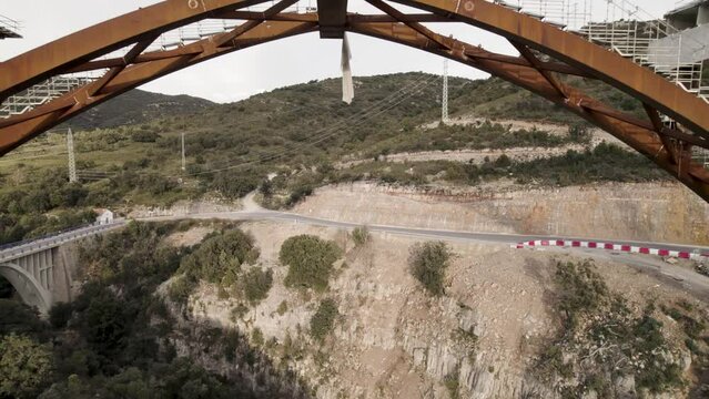 Backward motion video revealing a new bridge&acute;s structure and frame under construction in Barranco de la Bota in Morella