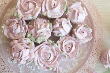 Roses, tulips and chrysanthemums from marshmallows. Zephyr flowers. Sprinkled with powdered sugar.