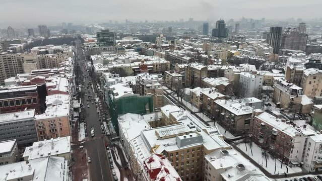 Drone shot of Kyiv, Ukrain Flying above the Zolotovoritska Street  toward the Golden Gate, by showing the whole city Kyiv, Ukrain in the winter
