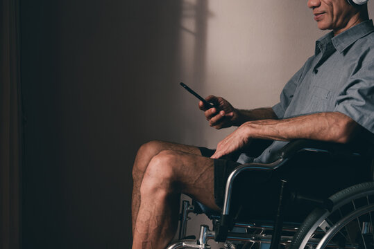 Man with disability using technology and social media, Hobbies to do to improve mental health, Prevent depression and stress that can lead to suicide, International Day of Persons with Disabilities.
