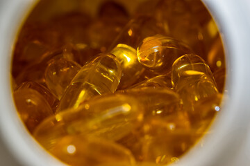 Photo of soft golden colored healthy Omega-3 dietary supplement.