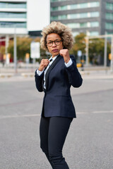 Portrait of business african american girl in fighting pose. Hard business concept