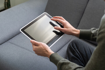 close up hands multitasking man using tablet, laptop and cellphone connecting wifi