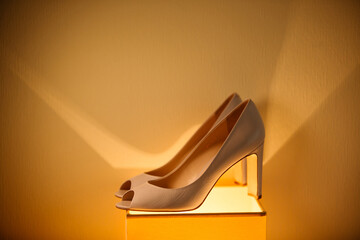 Stylish shoes under yellow light