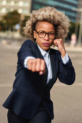 Portrait of business african american girl in fighting pose. Hard business concept