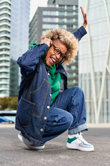 Portrait of happy african woman with curly hair. Afro american female outdoors.
