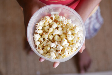 young man eating popcorn close up 