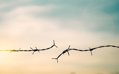 Barbed wire fence with sunset Twilight sky. Broke spike change transform to bird boundary concept...