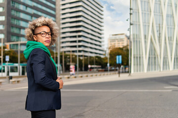Obraz premium Successful professional posing near office building. Young African American business woman. Female business leader concept