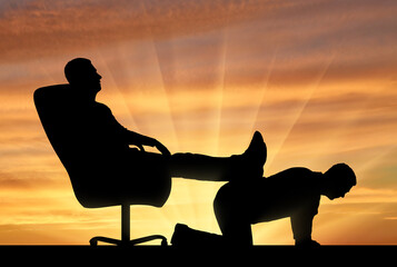 Silhouette of a selfish man sitting in a chair, threw back his legs on the back of a man