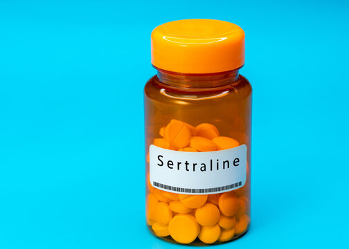 Medical vial with Sertraline pills. Medical pills in orange Plastic Prescription
