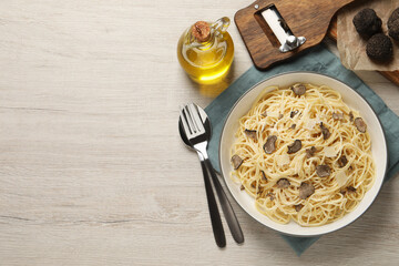 Tasty spaghetti with truffle served on wooden table, flat lay. Space for text - obrazy, fototapety, plakaty