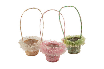 Stack of wicker straw osier handmade baskets different size and pattern at isolated white...