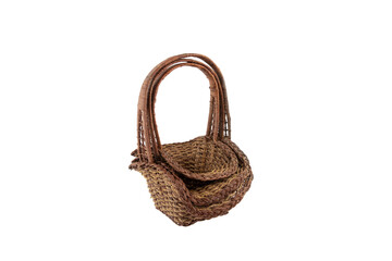 Stack of wicker straw osier handmade baskets different size and pattern at isolated white...