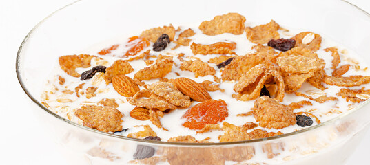Close up of muesli bowl with fresh milk. Breakfast cereals. Healthy eating concept