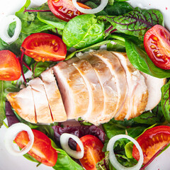 easter salad chicken breast with vegetables tomato, onion, green lettuce mix leaves veggie fresh portion healthy meal food diet snack on the table copy space food background rustic keto or paleo diet